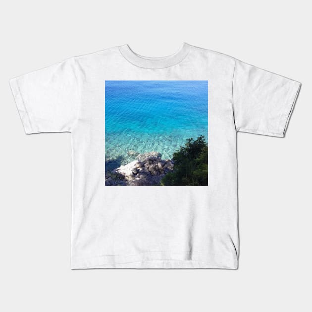 Clear Ocean Water Rocky Beach Photo Kids T-Shirt by OneLook